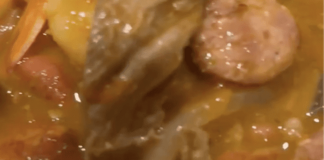 Stew with vegetables and sausage slices.